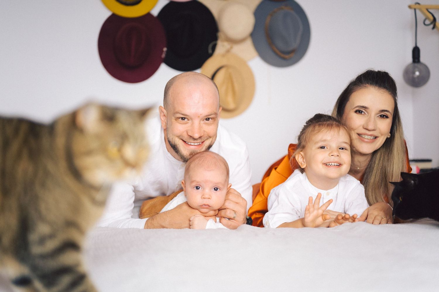 A black cat peeks out in sections of multiple cozy family photos showing heartwarming moments together.