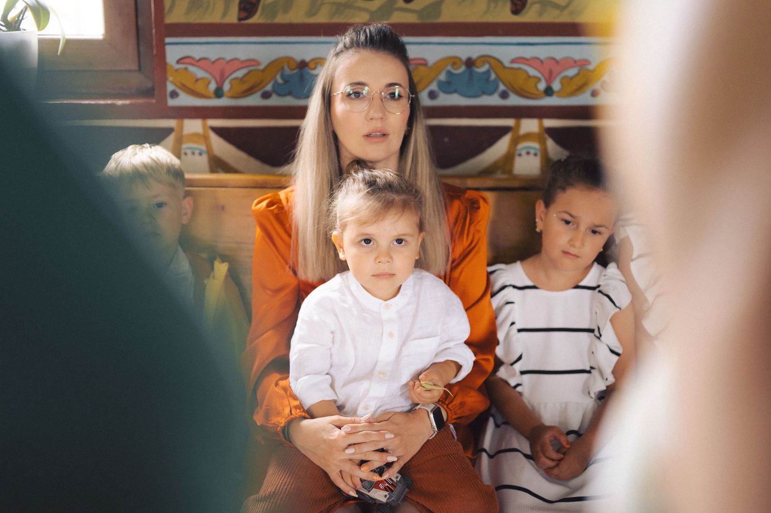 A montage of babies and toddlers wearing white and striped shirts sitting and playing indoors.
