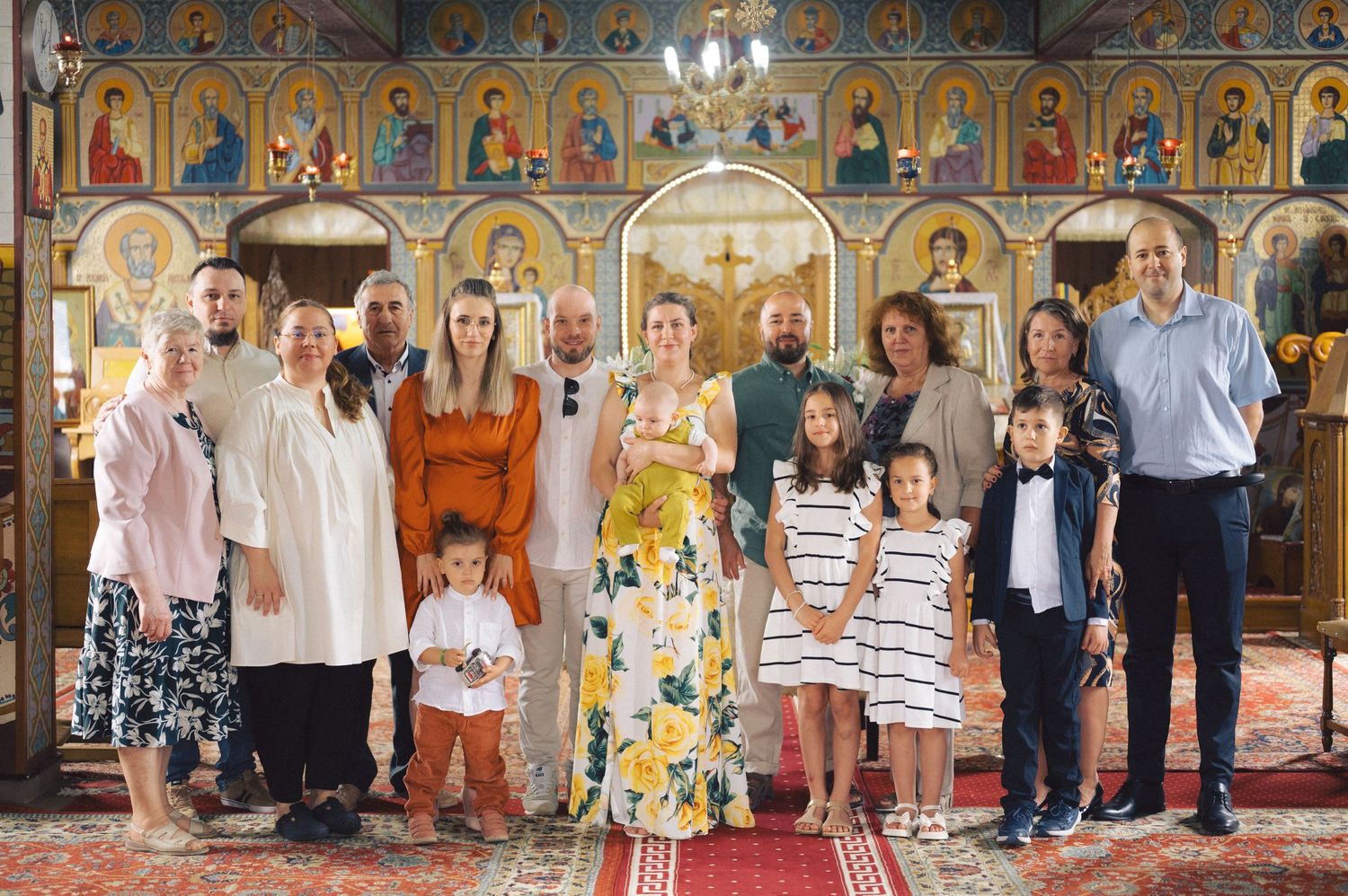 Group of people standing together in an ornate church interior with decorative golden walls and ceiling.
