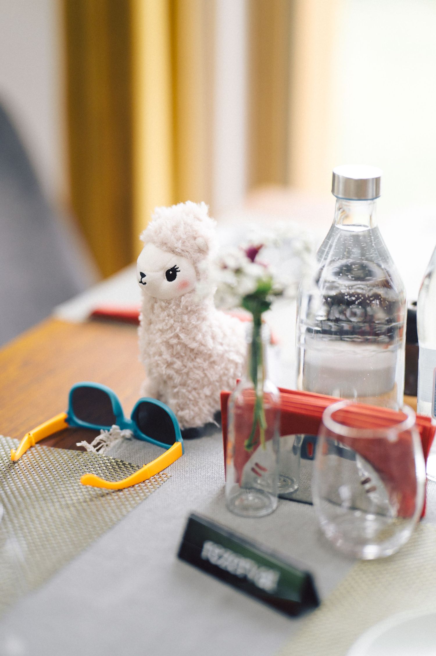 Science lab equipment including sunglasses, glass jars, and fluffy white objects arranged in a sequence of similar shots.