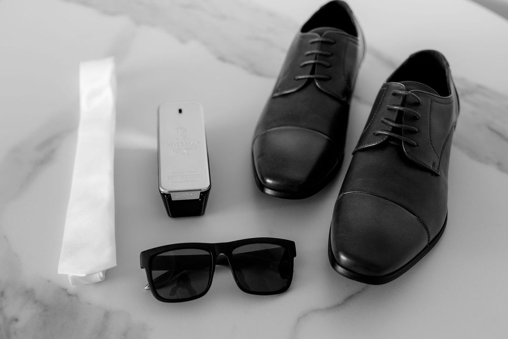 Collection of black leather dress shoes arranged in a row showing different angles and styles.