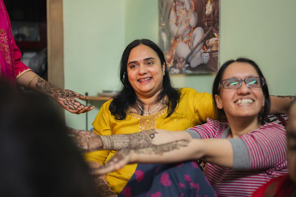 Two people sharing a joyful moment while laughing together during a traditional celebration.