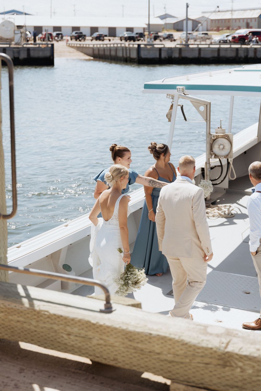 Joyful wedding party portraits at a New Brunswick wharf, Cap Pele beach wedding photos wedding party photography Moncton editorial photos