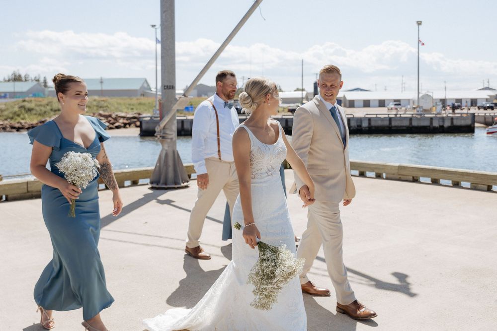 Joyful wedding party portraits at a New Brunswick wharf, Cap Pele beach wedding Elegant bridal party photos in Dieppe New Brunswick.