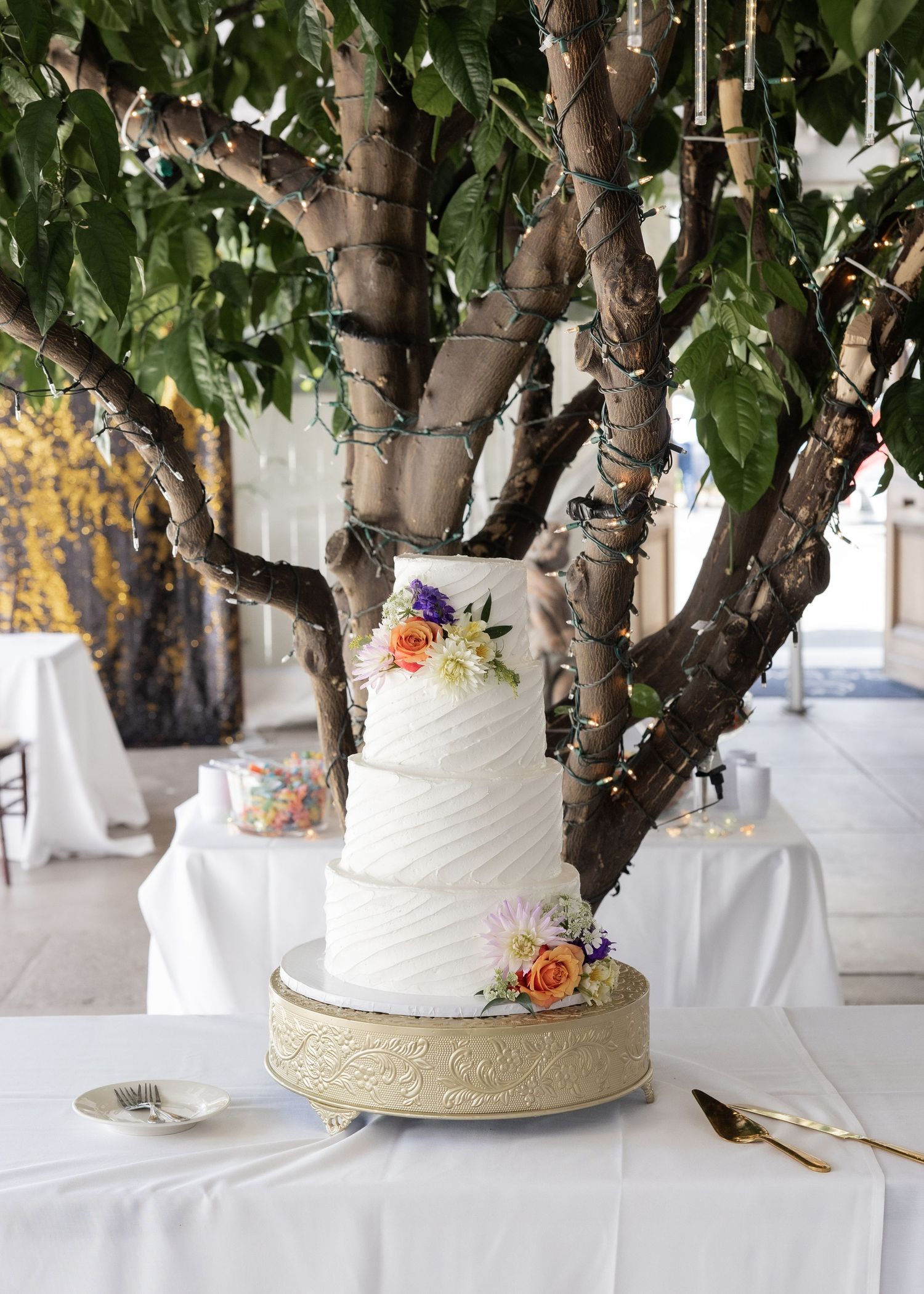 Custom Wedding Cake with florals in Jefferson Street Mansion reception space
