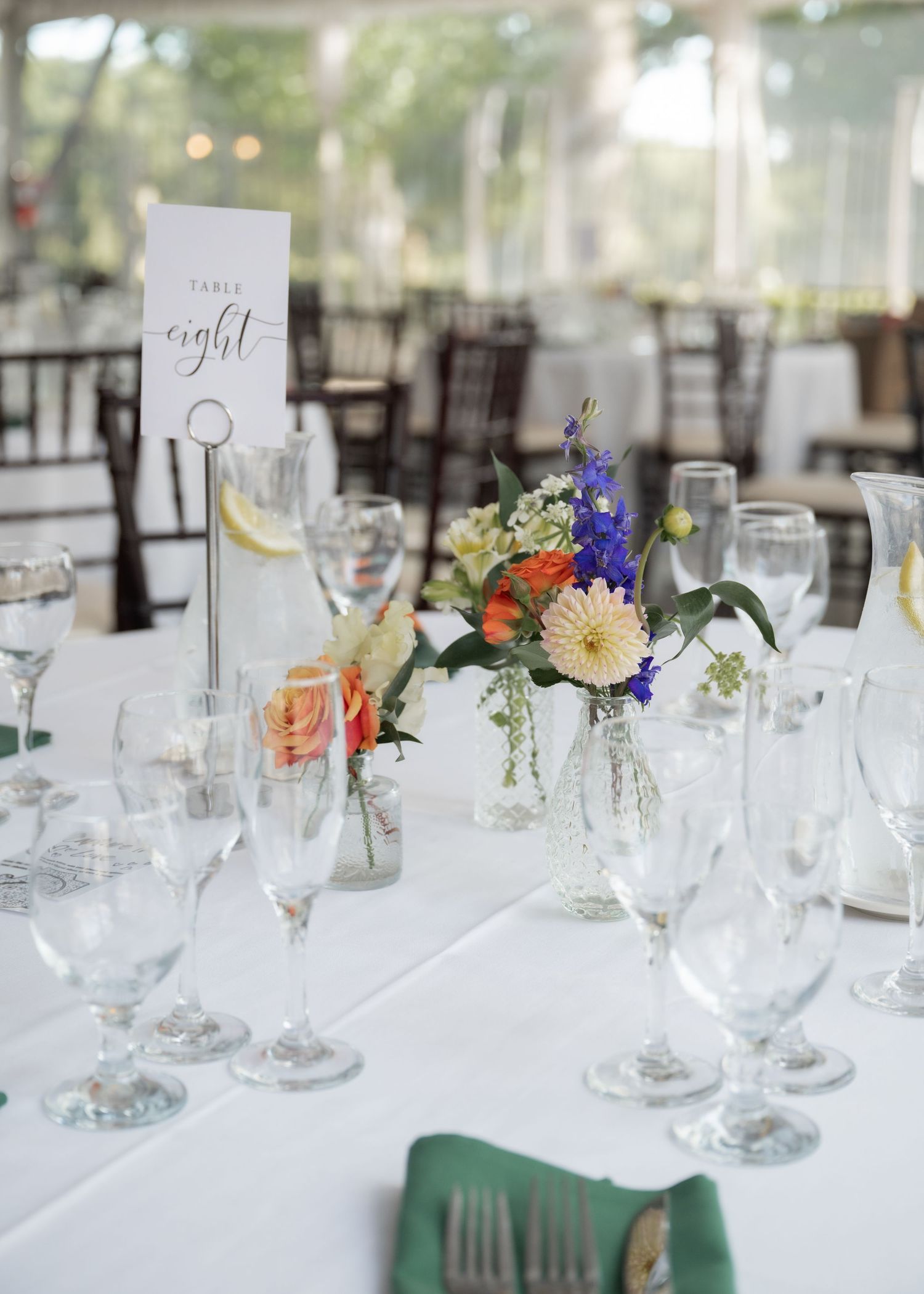 Decorated tables and floral centerpieces in Jefferson Street Mansion reception space