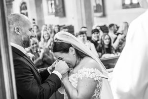A black and white photo collage of a wedding celebration showing emotional moments between couples and guests.
