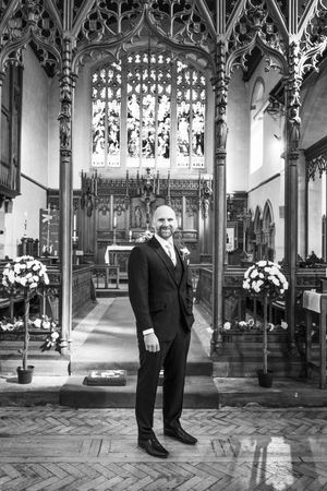 Black and white portraits of wedding party members in an elegant Gothic cathedral interior.