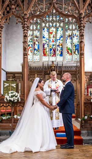 Beautiful wedding ceremony captured in a sequence of moments inside an ornate church with stained glass windows and wood carvings.