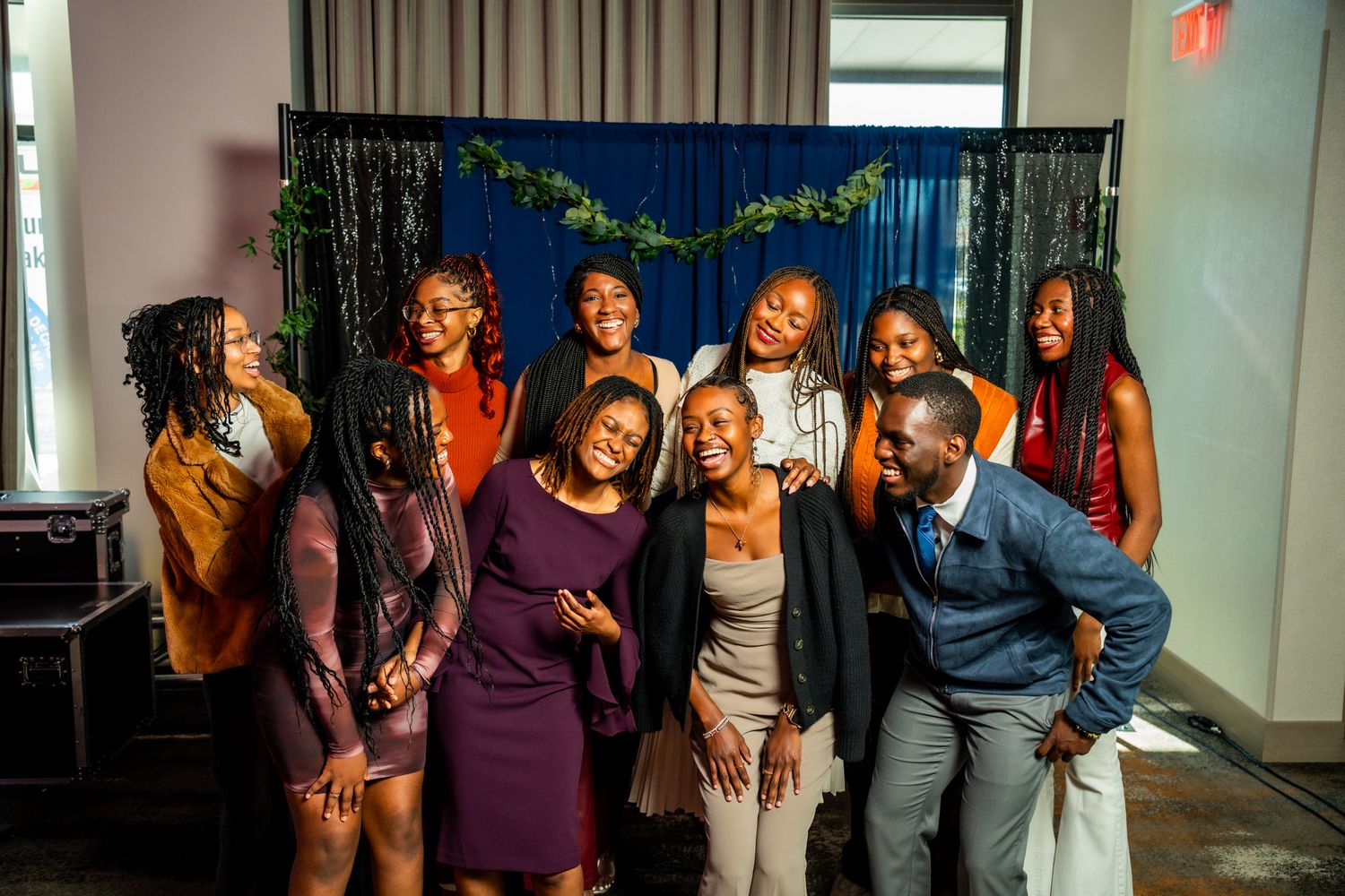 Group photo showing people in coordinated outfits at an indoor celebration.