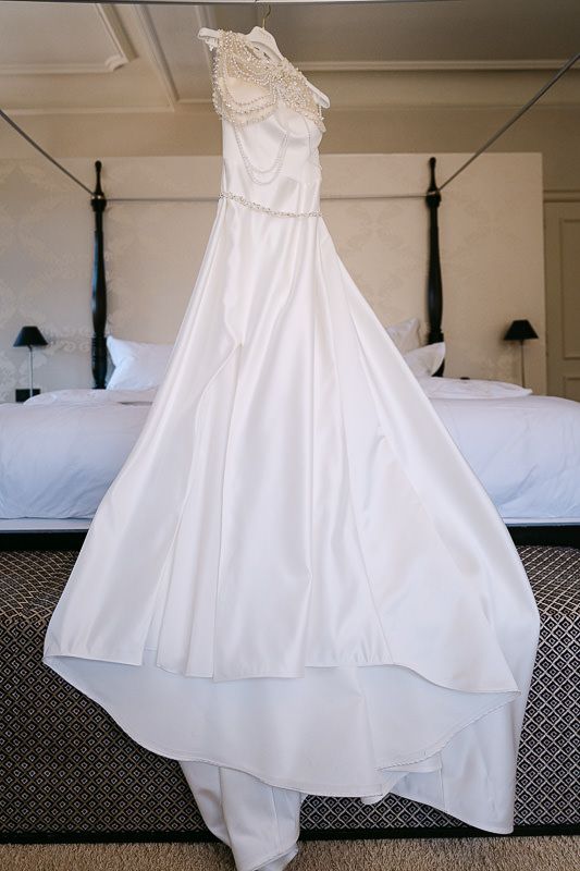 Wedding dress hanging in bridal suite at Manoir de Lébioles