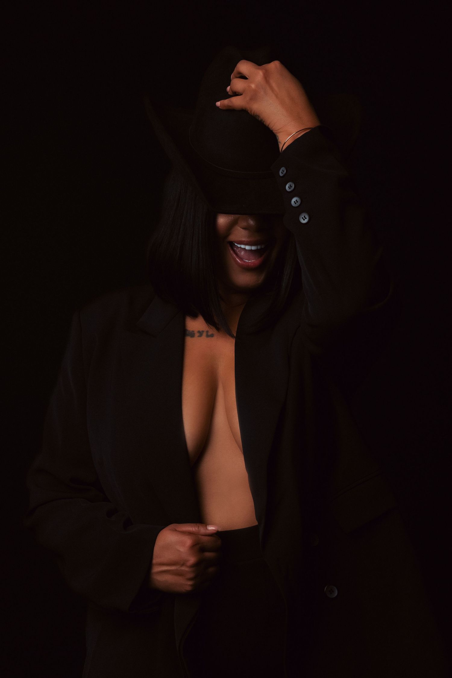 Dark artsy portrait series showing cropped facial features with dramatic lighting and shadows on black background.