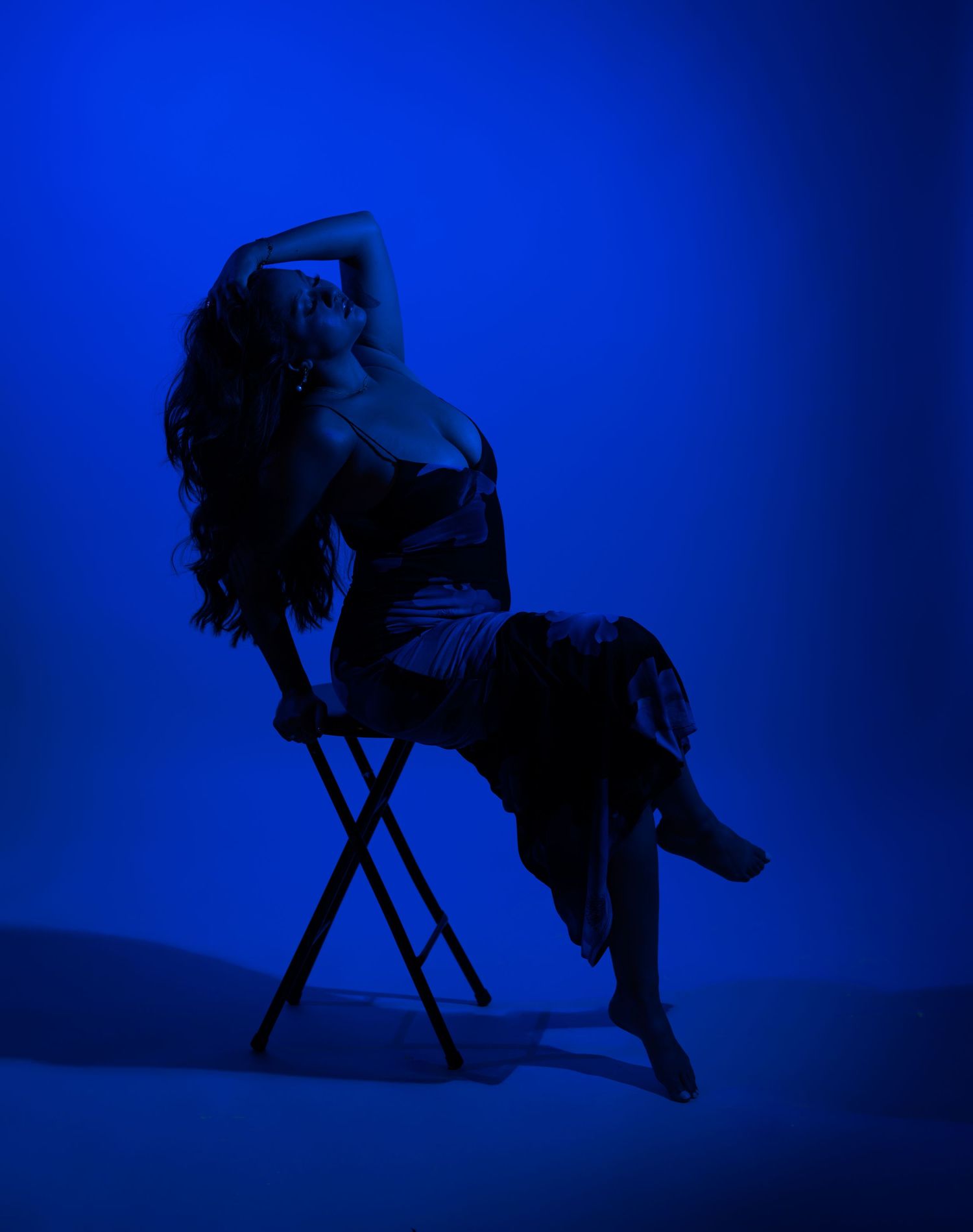 Silhouetted figure performing various aerial movements in a sequence against a deep blue background.