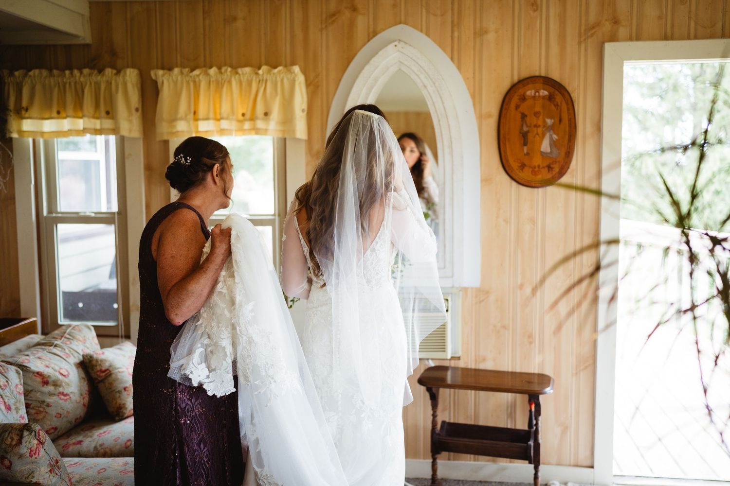 Series of artistic black and white wedding preparation photos in a rustic wooden room with natural light.