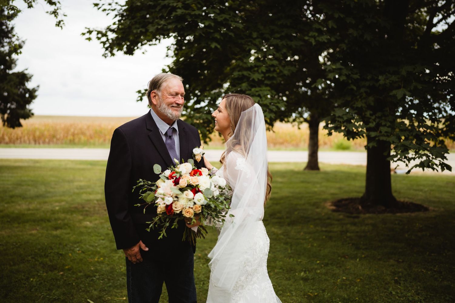 A romantic outdoor wedding photography session in a dreamy natural setting with golden light filtering through trees.