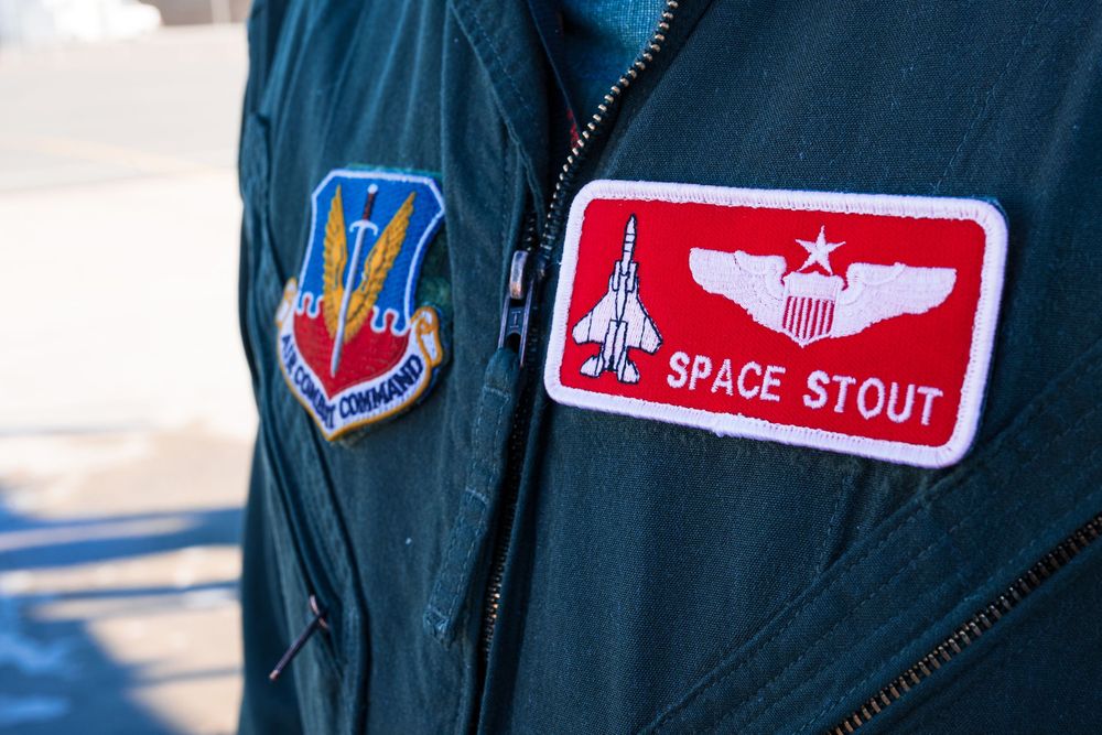 Close-up view of military flight patches and insignia on a uniform.