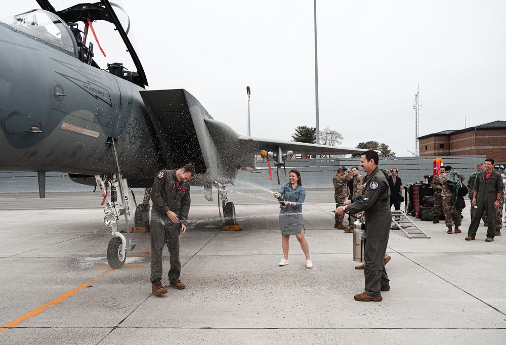 Military personnel inspecting an aircraft on the tarmac during pre-flight checks.