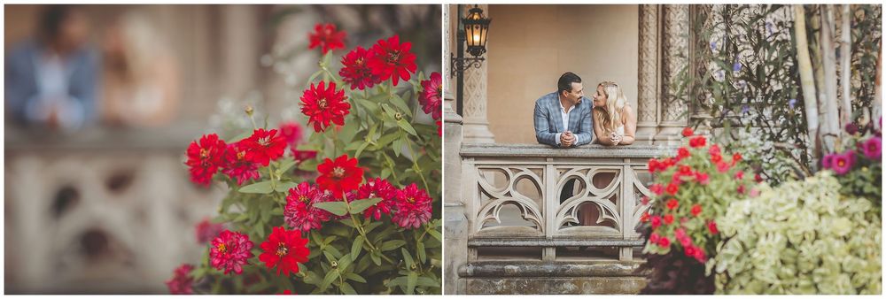 Bright red bougainvillea flowers cascade down stone walls against a rustic Mediterranean architectural backdrop.