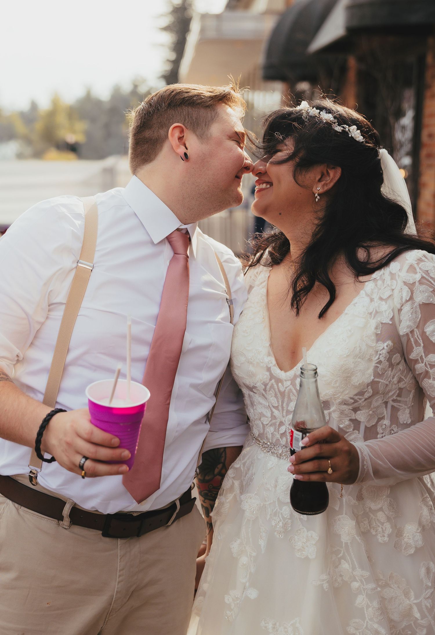 Romantic wedding couple shares intimate moments in a series of candid photos showing them holding drinks and embracing.