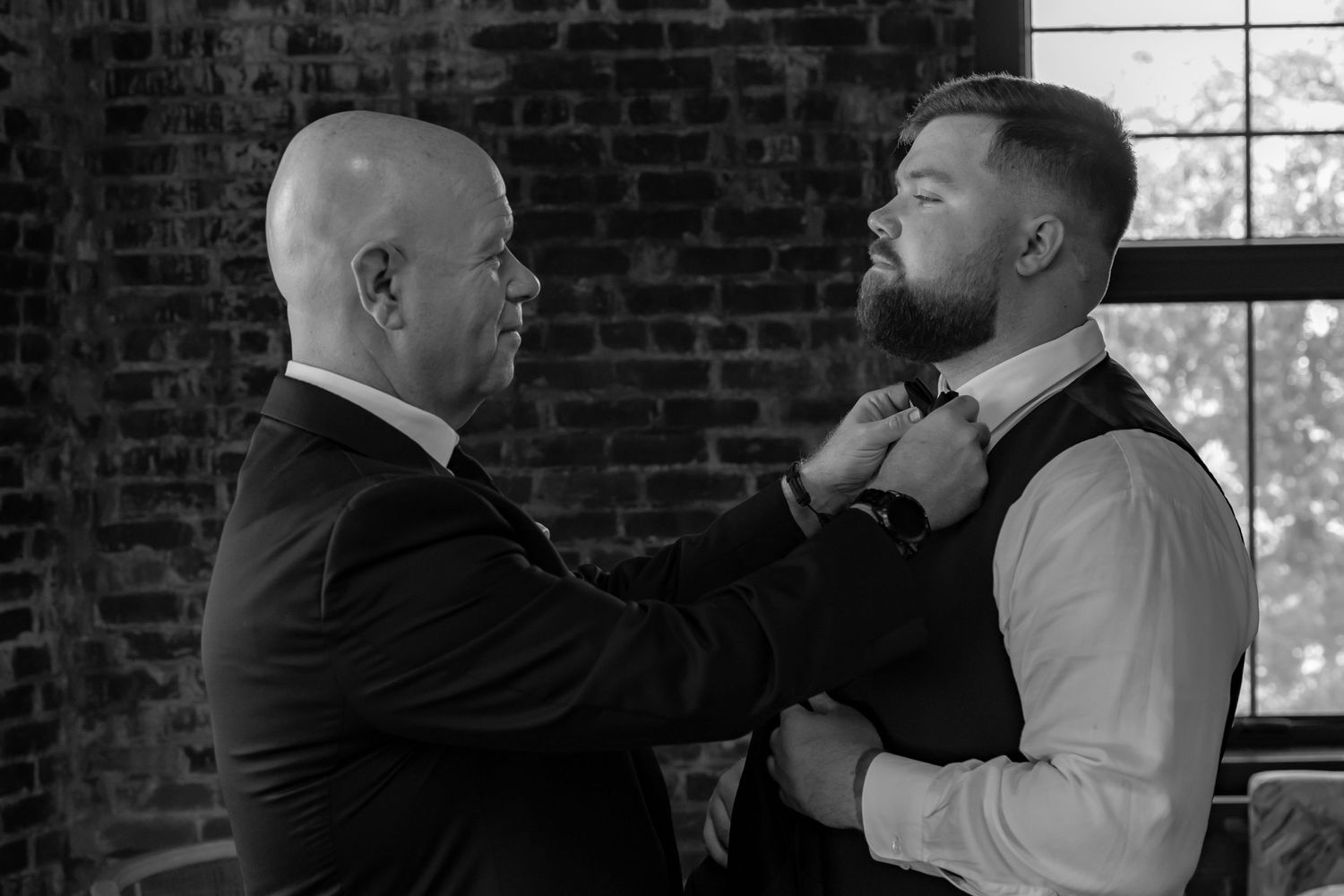 Black and white formal gathering photos showing people interacting at an indoor event.