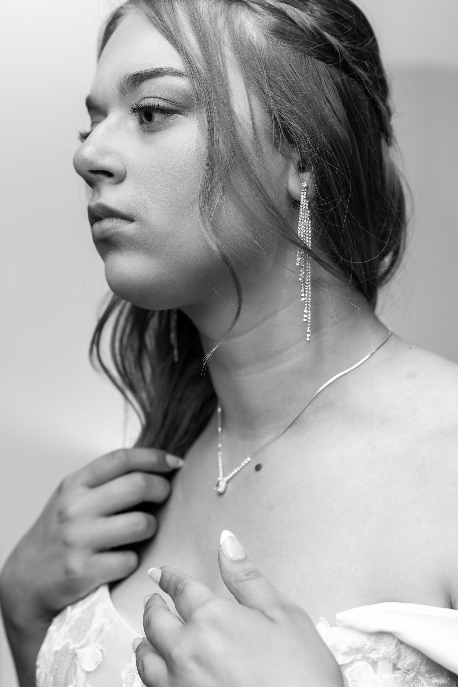 Black and white editorial style portraits featuring delicate necklace and natural lighting.