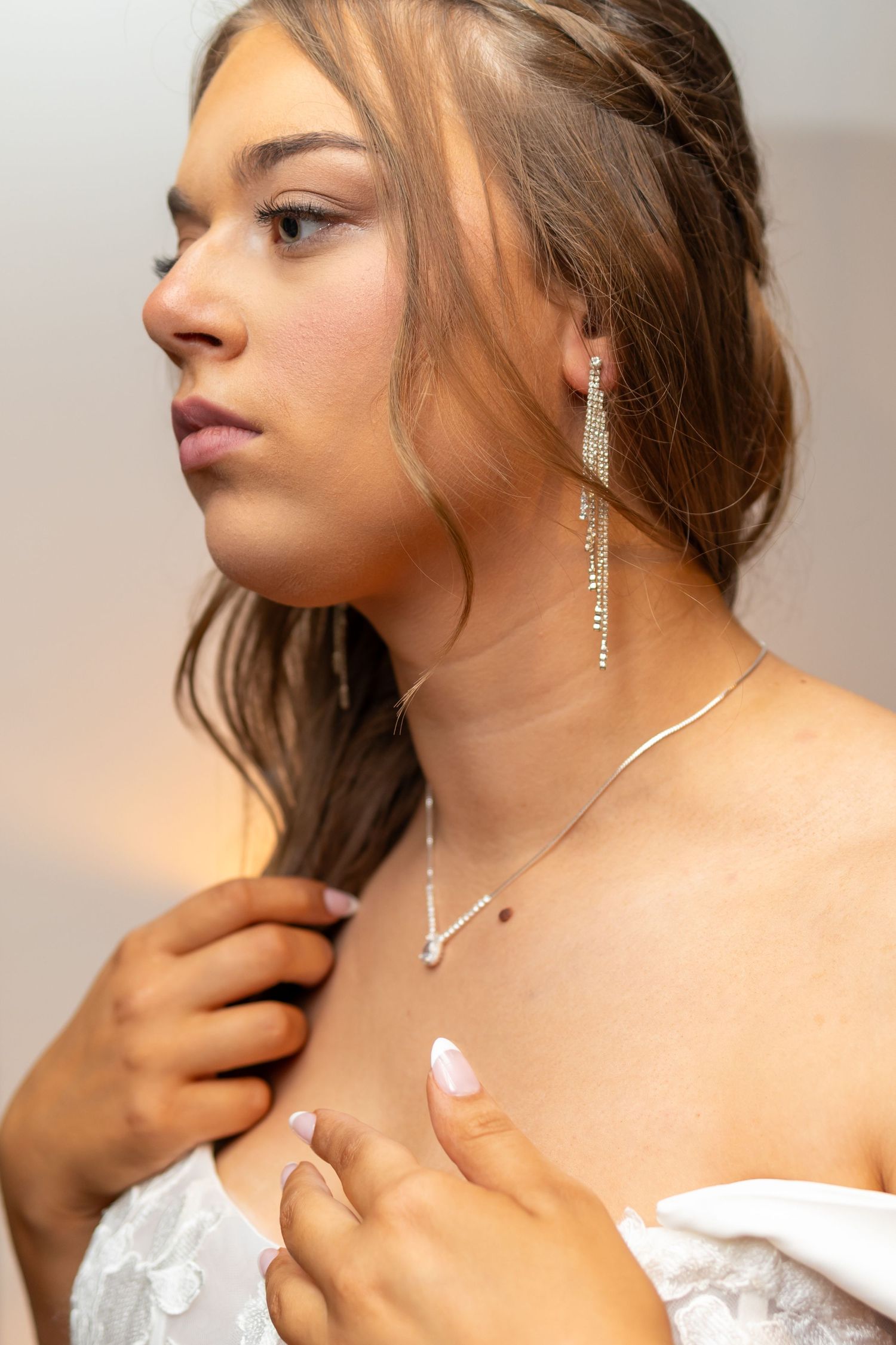 Elegant portrait series showing sophisticated jewelry styling against neutral background.