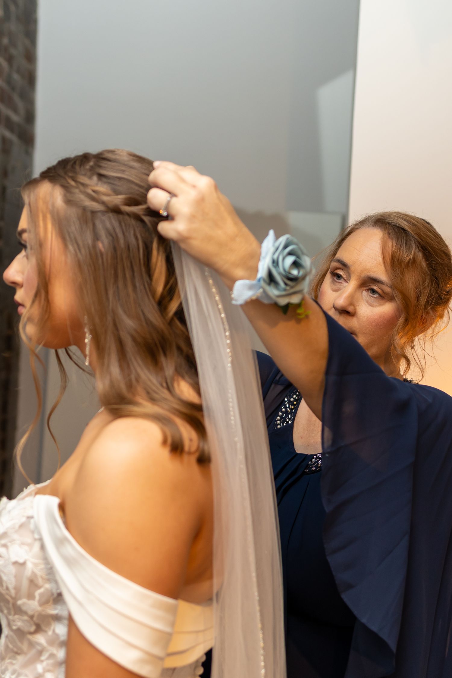 A sequential photo series showing hands helping a bride put on her wedding veil during pre-ceremony preparations.