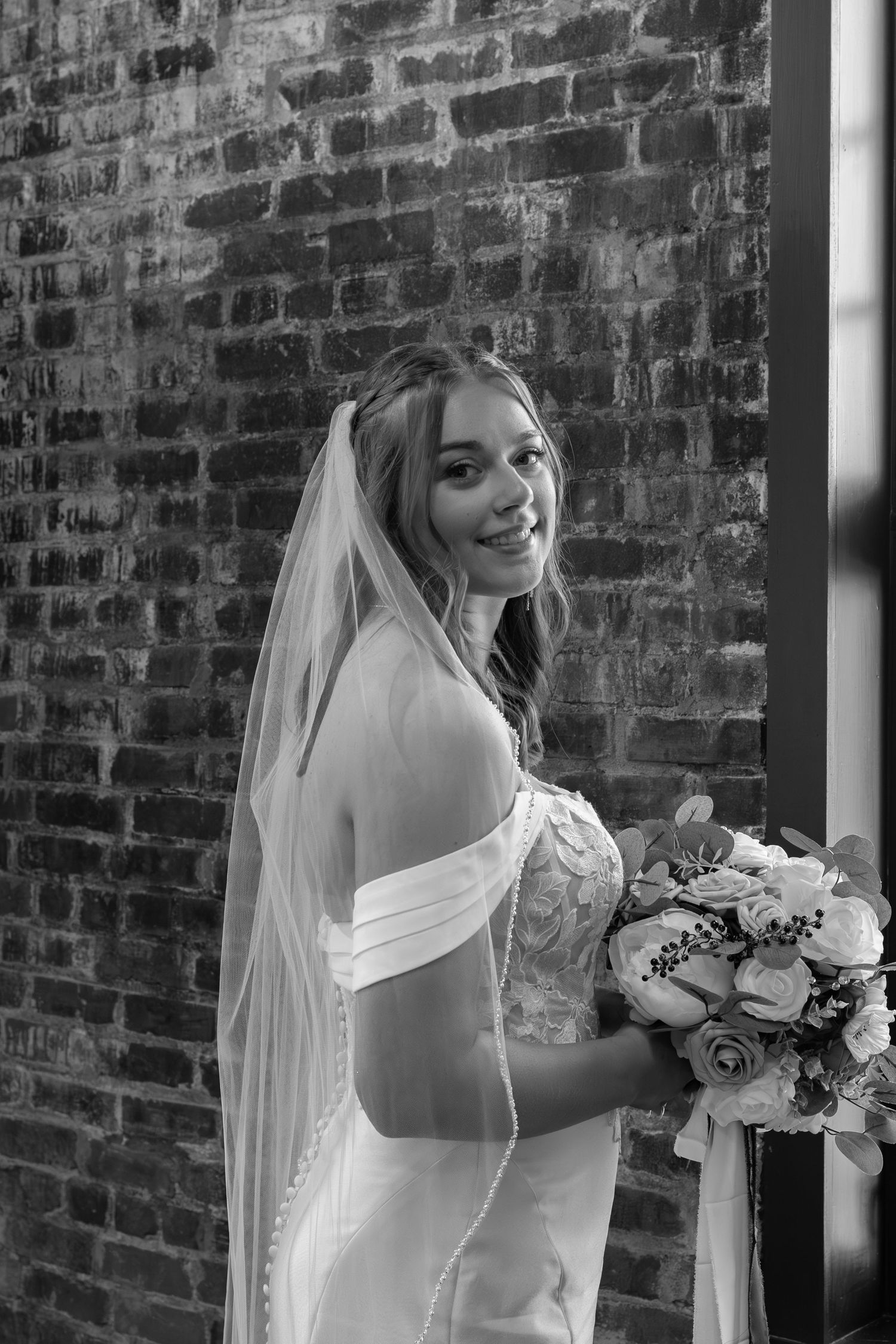 A classic black and white photo series of a bride in a traditional white gown with lace details and veil.