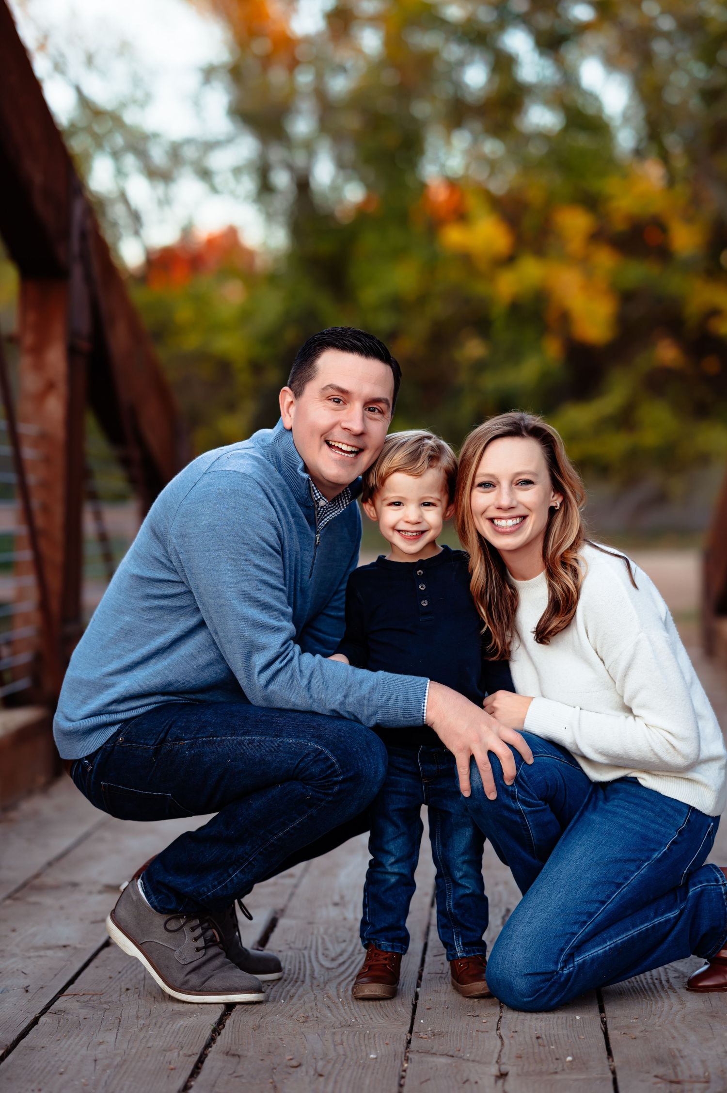 dallas family outdoor fall mini session mom and dad with smiling toddler between