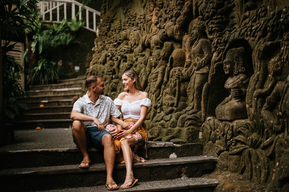 Stone steps and walls create a pathway through a lush tropical garden setting.