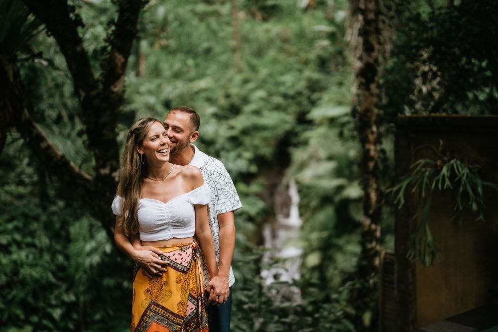 An intimate moment captured in a verdant forest setting with natural lighting.