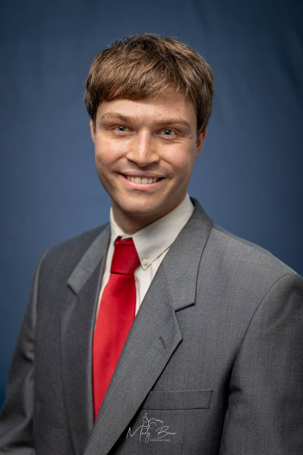 Corporate man in suit sitting studio portrait