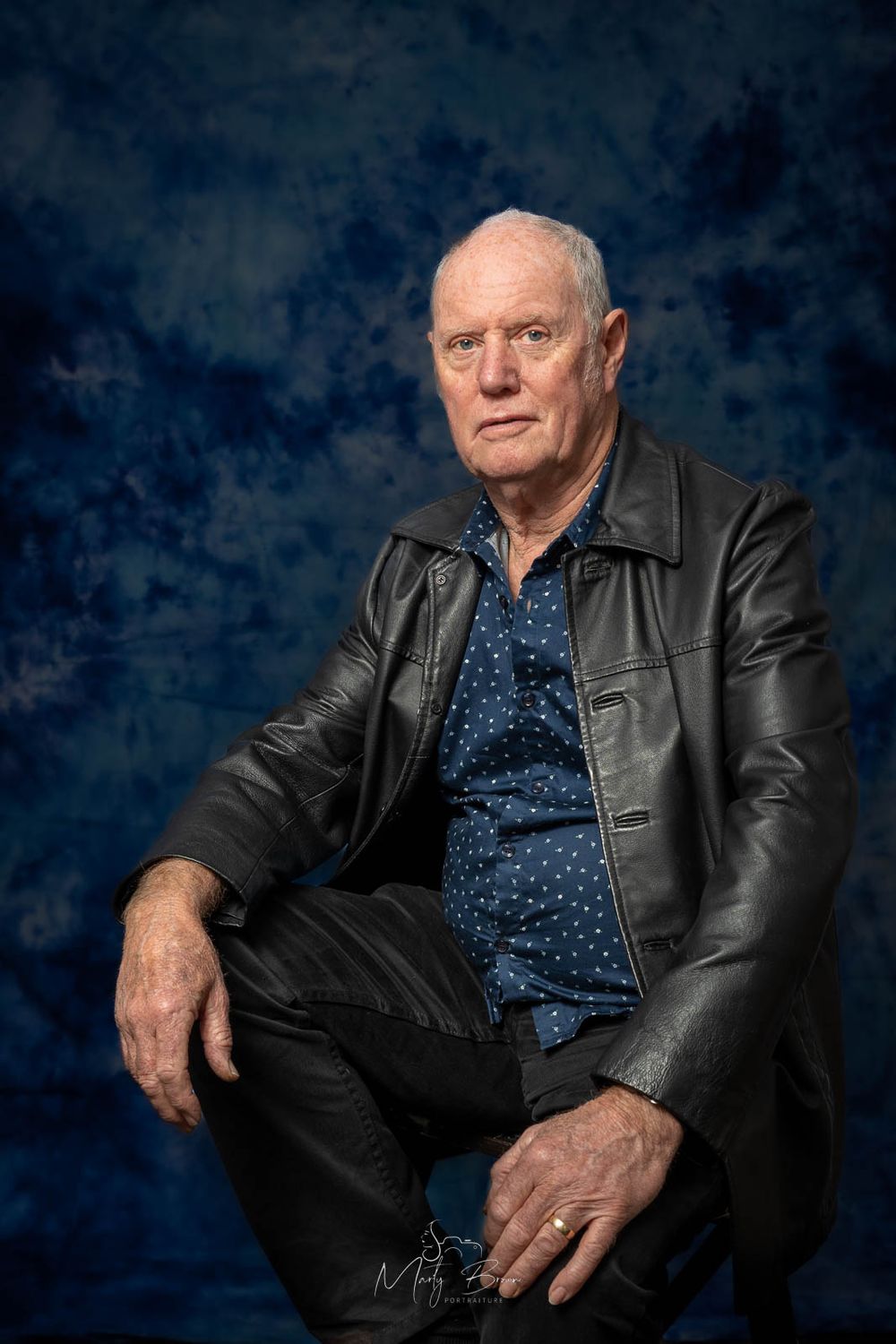 Corporate man in suit sitting studio portrait