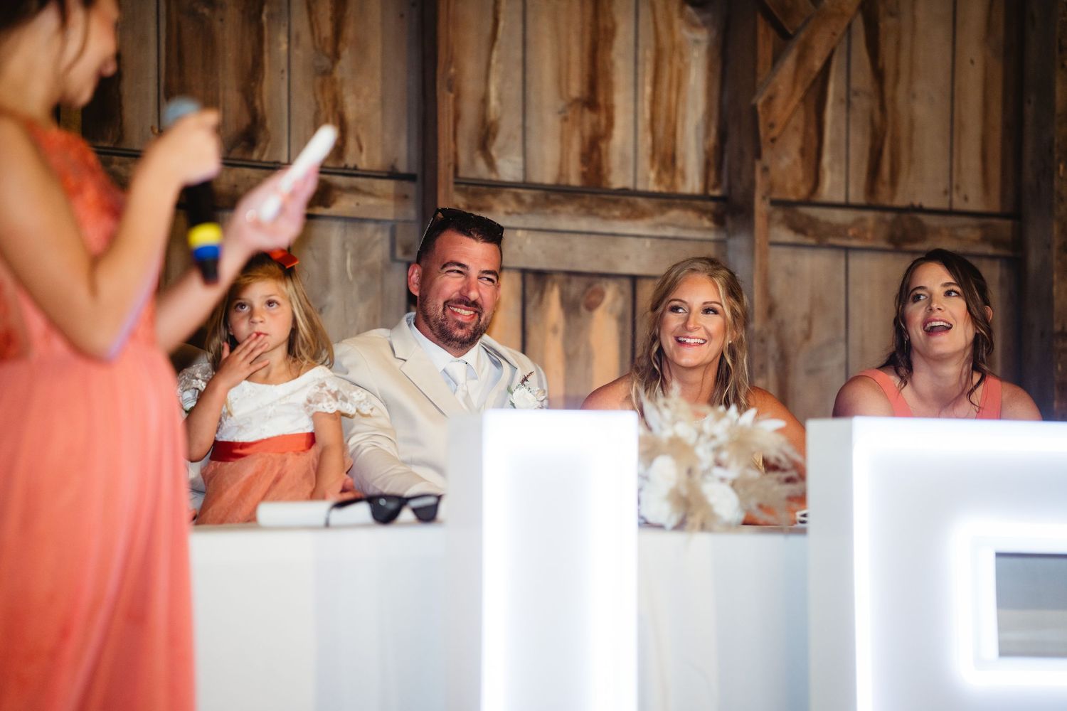 A wedding celebration montage showing dancing and joyful moments in a rustic barn setting.