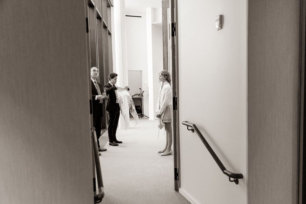 Minimalist hallway interior with black and white photography showing multiple doorways.