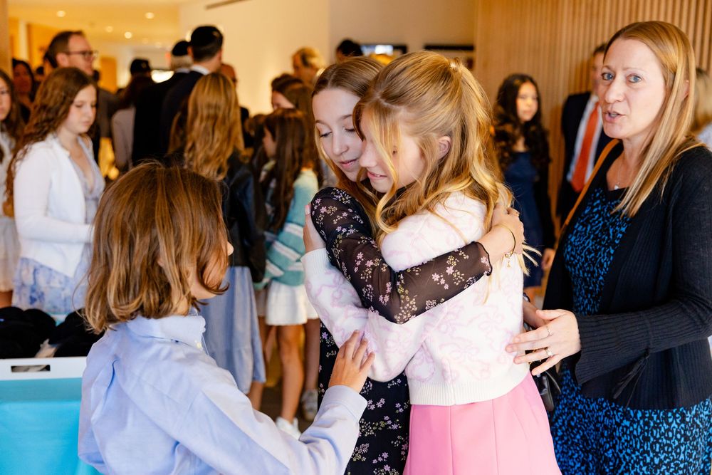 Group of party guests gathering and mingling at an elegant indoor venue.