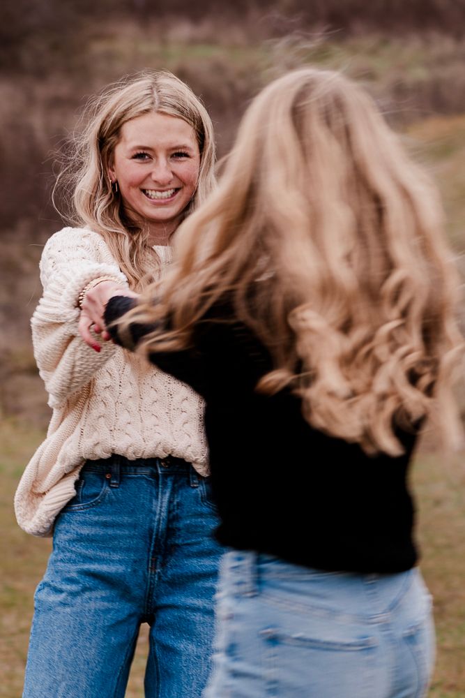 Two people in casual denim and sweaters share joyful moments outdoors.