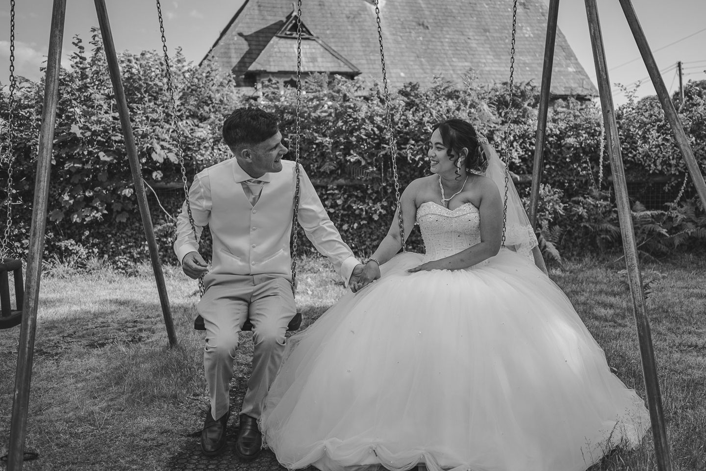 Dorset Wedding photographer, Kris the photographer,  taking a couples photo with a fun  bride and groom