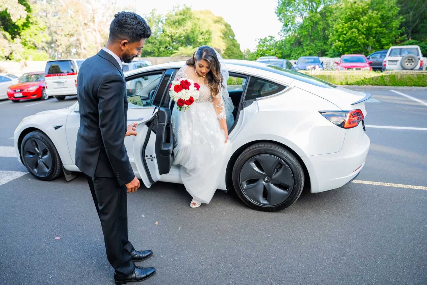 A series of wedding photos showing details of a bride in white dress next to a silver sports car in parking lot.