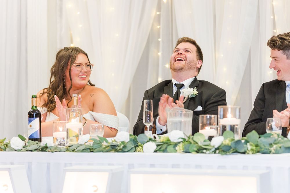 A series of wedding reception photos showing joyful moments and laughter at the head table with floral decorations.