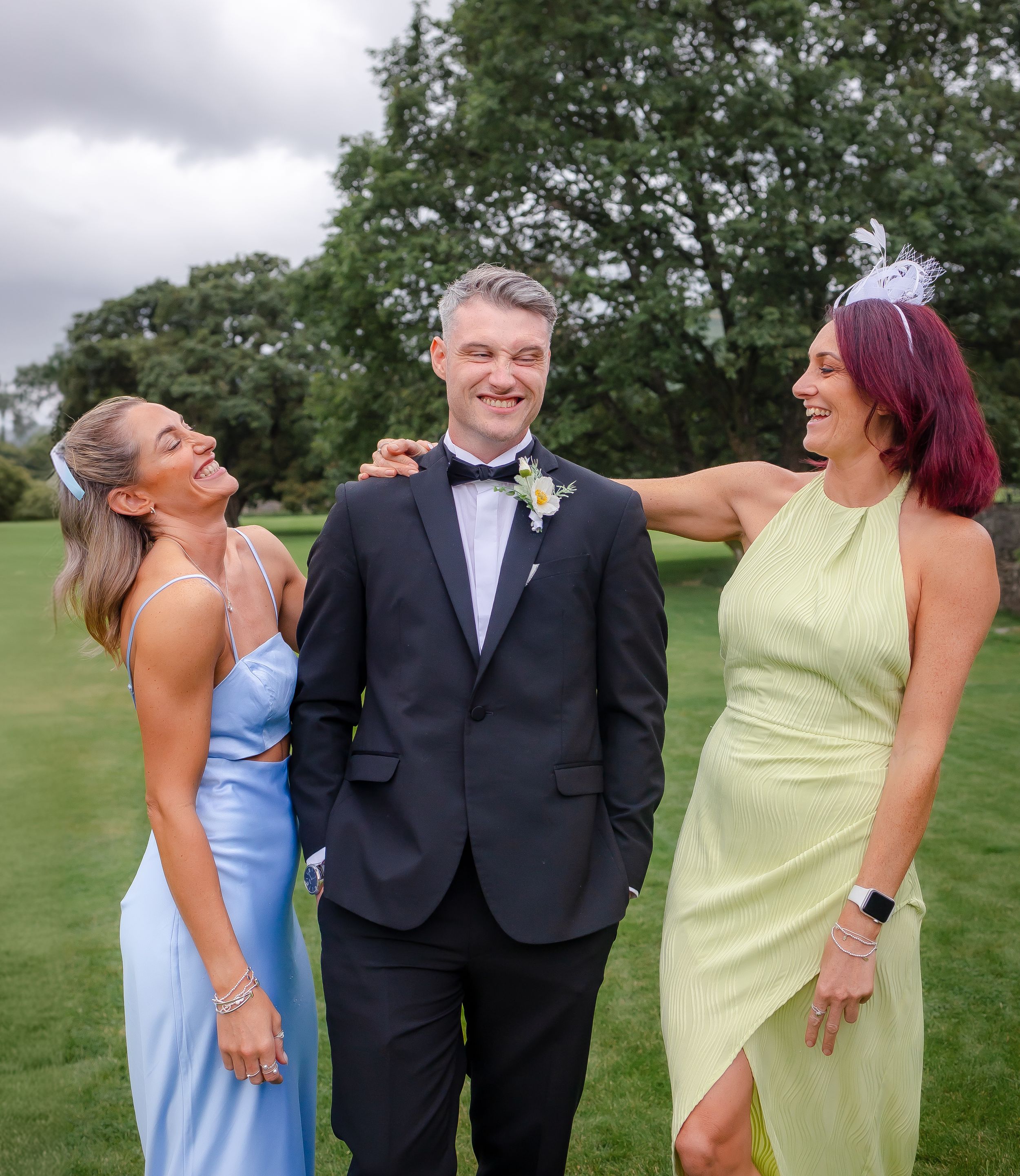 wedding photography in Cumbria - groom pulling funny faces at sisters