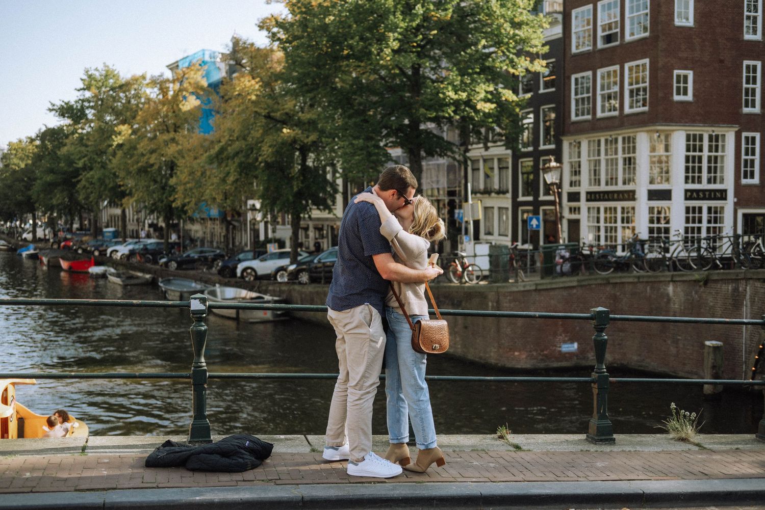 Engaged couple strolling through the charming streets of Jordaan district.
