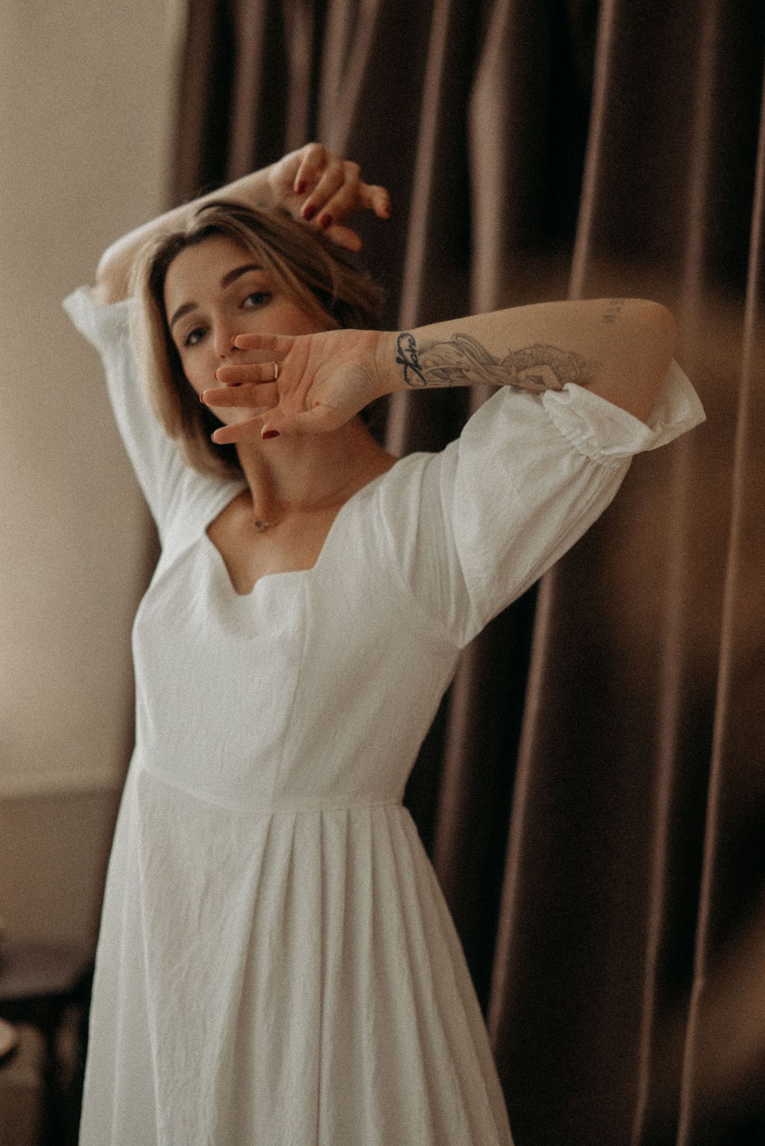 Relaxed, cozy indoor portrait with minimal styling and personal details.