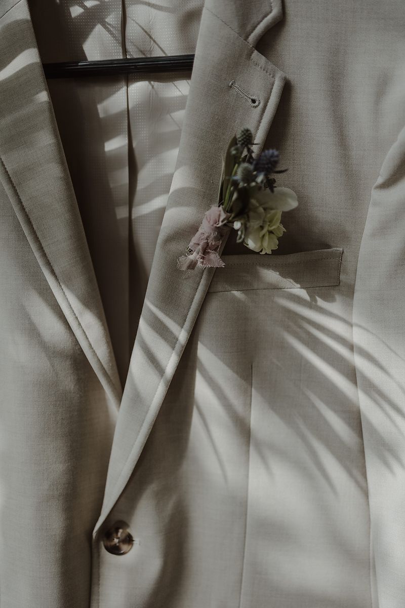 Groom’s linen suit and boutonniere detail during intimate elopement at La Valise Tulum Riviera Maya wedding photographer.