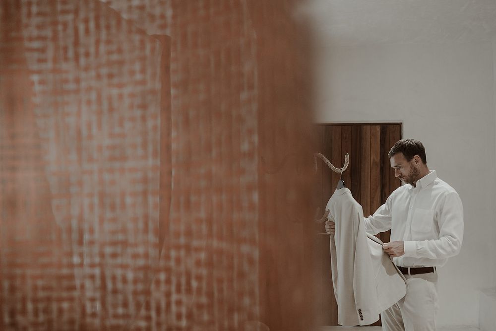 Groom getting ready in jungle suite with Mexican design during La Valise Tulum elopement Riviera Maya wedding photographer.