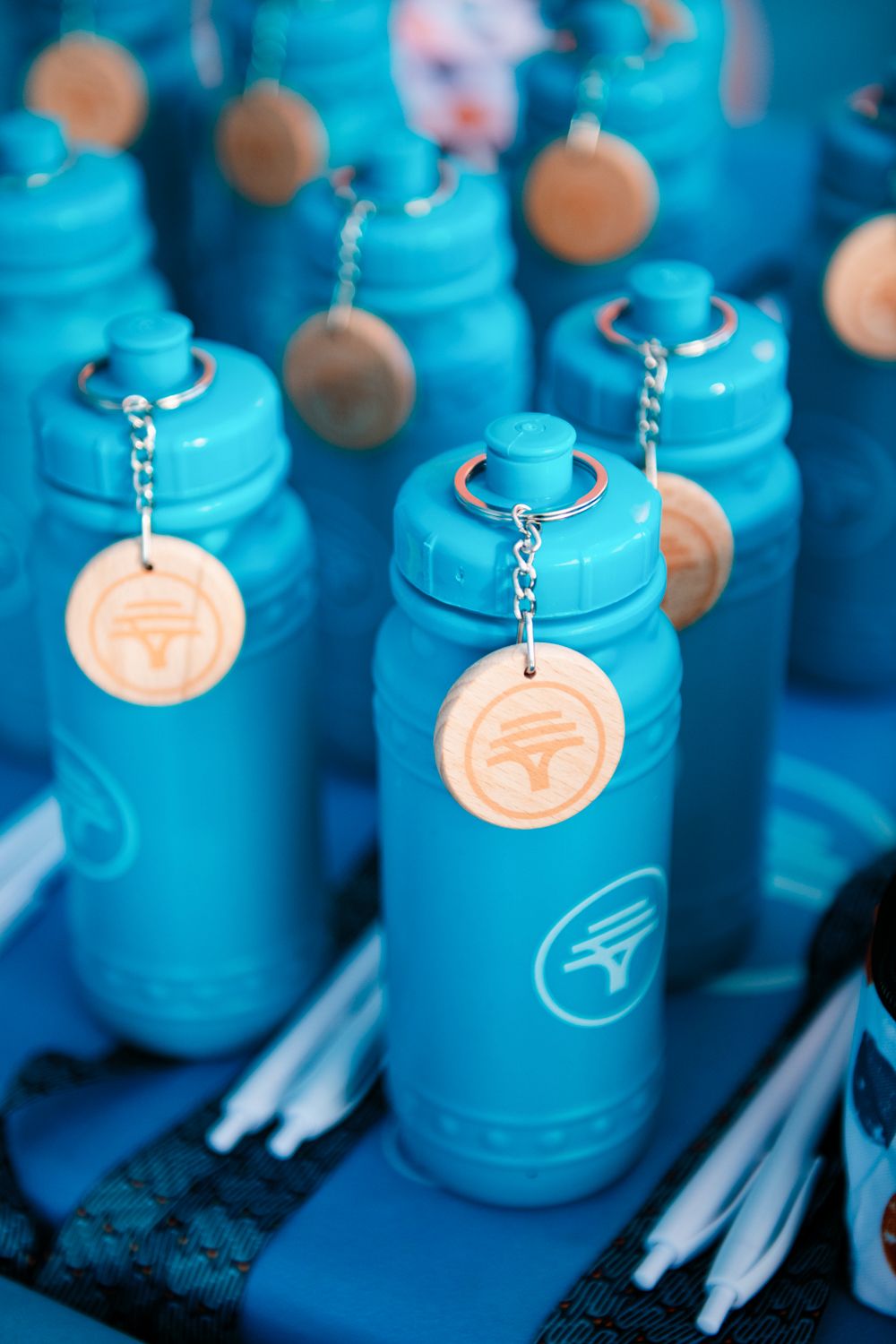 Close up image of a display of FNB branded waterbottles and branded pens, displayed on a table, at an FNB event in Soweto, South Africa.