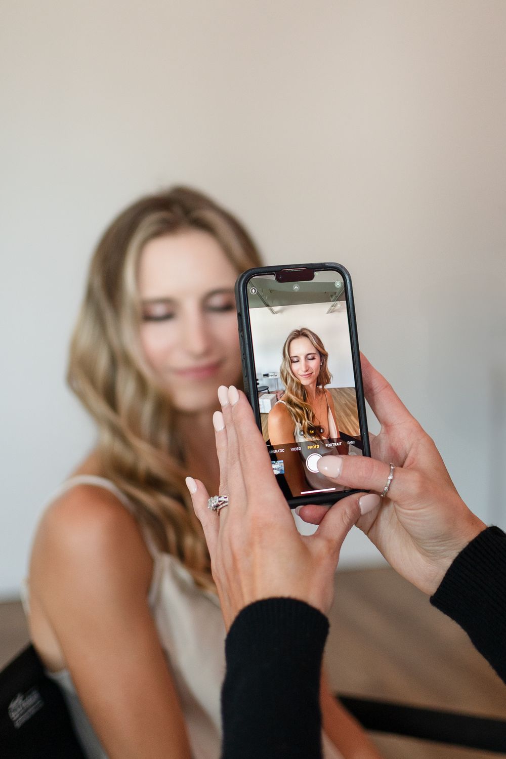 Behind the scenes photo shoot with smartphone camera capturing portrait.