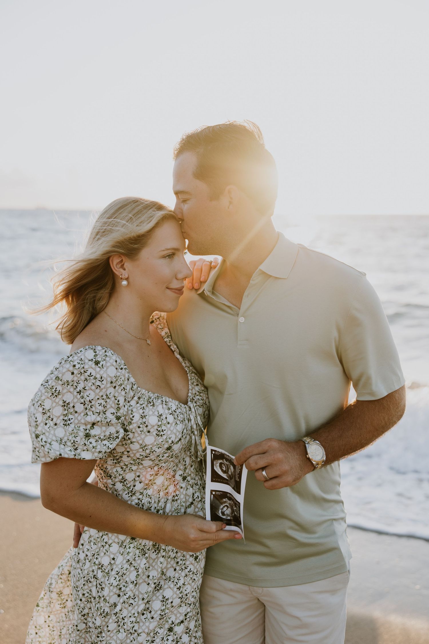 Sunrise summer pregnancy announcement photos on the beach captured by Lindsay McDow Photography