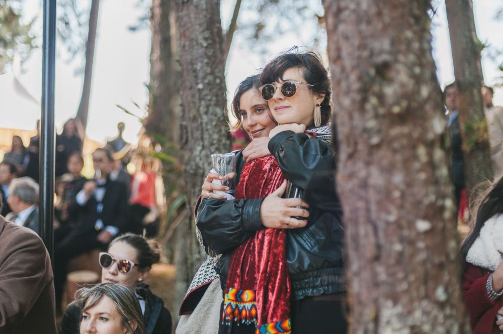 Wedding guests holding each other during wedding ceremony in Colombia.