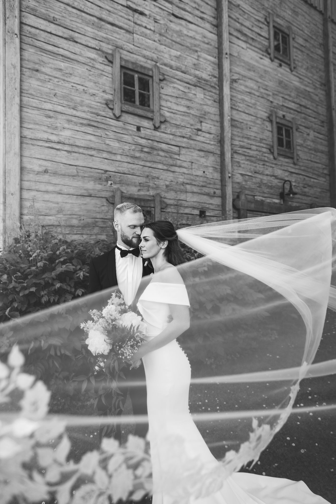 A black and white vintage photo collage showing a wedding ceremony and celebration at a rustic venue.